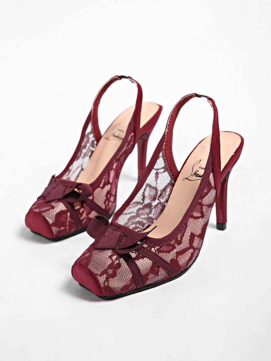 Black lace high heel sandals for women with a big bowknot, closed square toe, and stiletto heel.