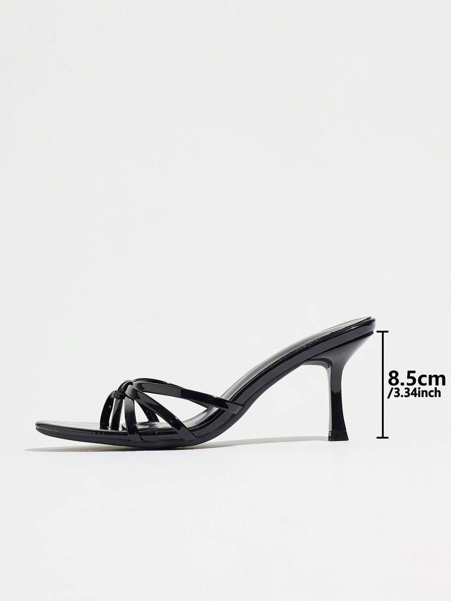 Women's slip-on stiletto heel platform sandals featuring a twist toe-post strap design and sleek finish.