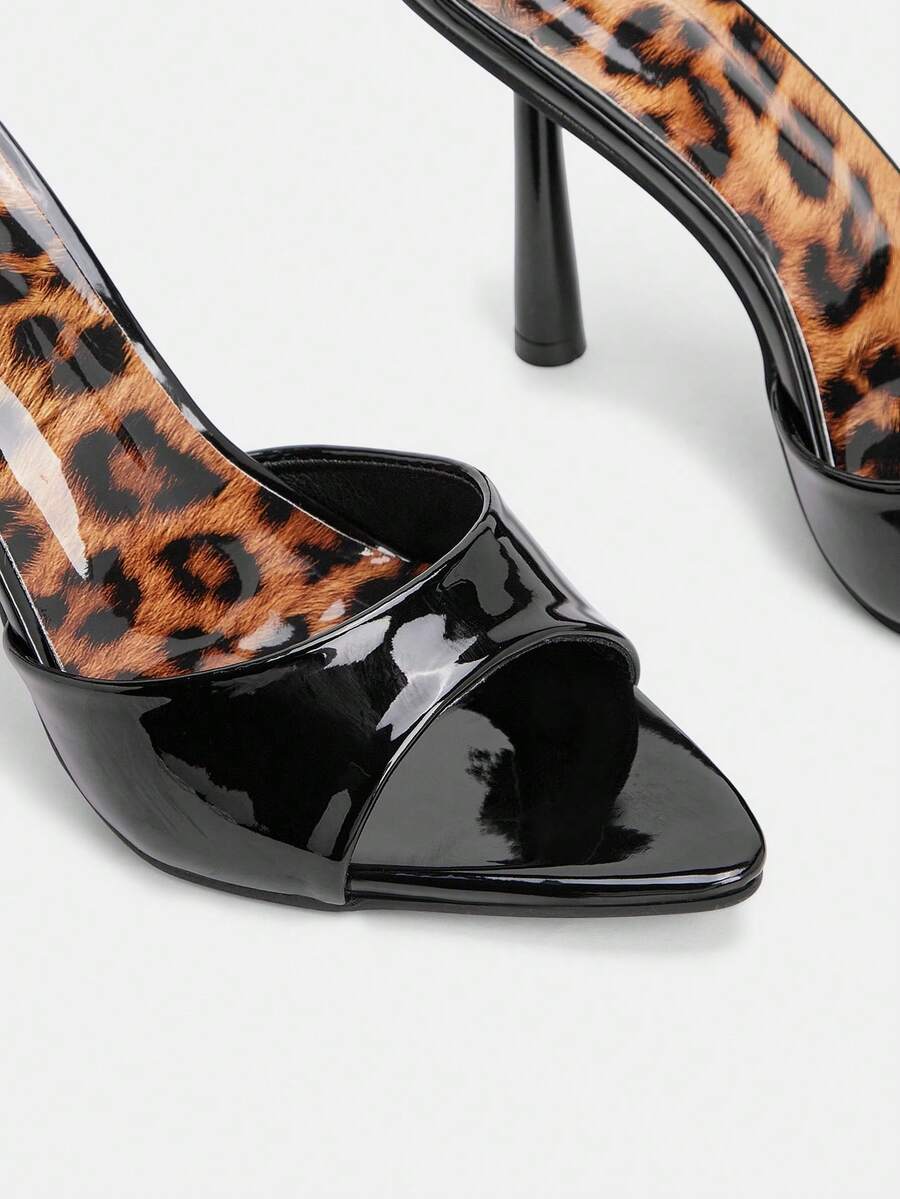Women's black pointed toe high heel mule sandals featuring pyramid decor accents on a sleek slip-on silhouette.
