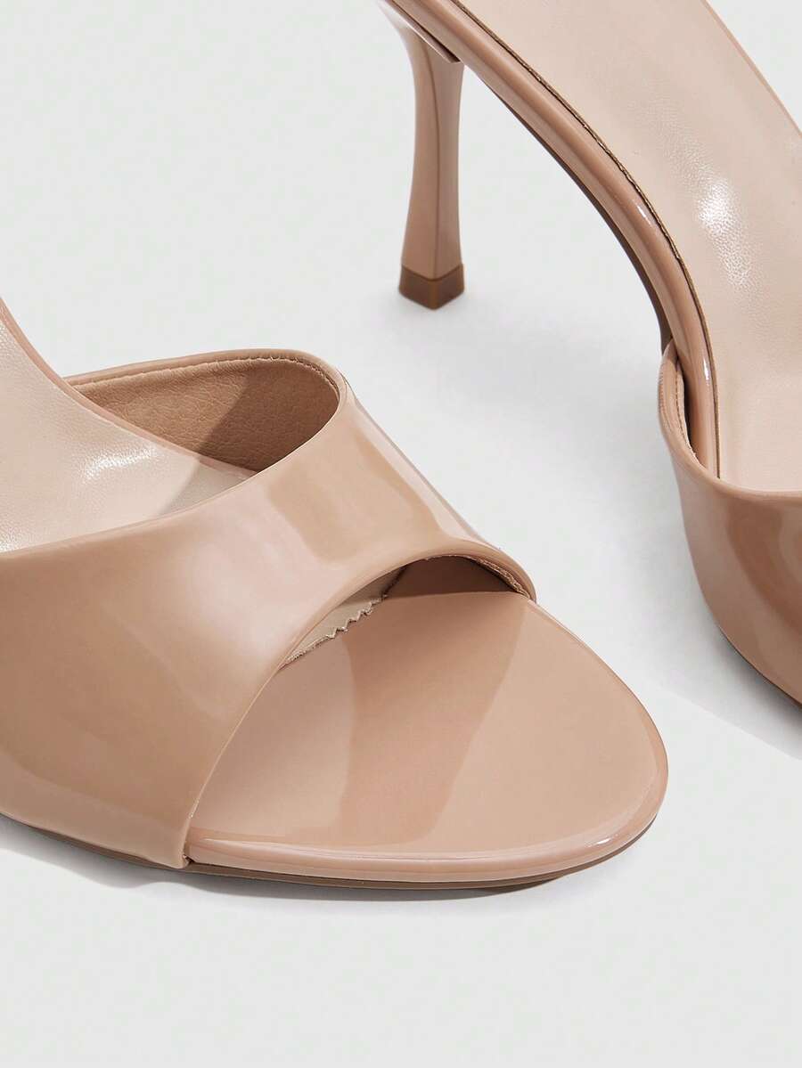 Women's peep toe high-heeled stiletto sandals with slingback strap in light metallic finish.