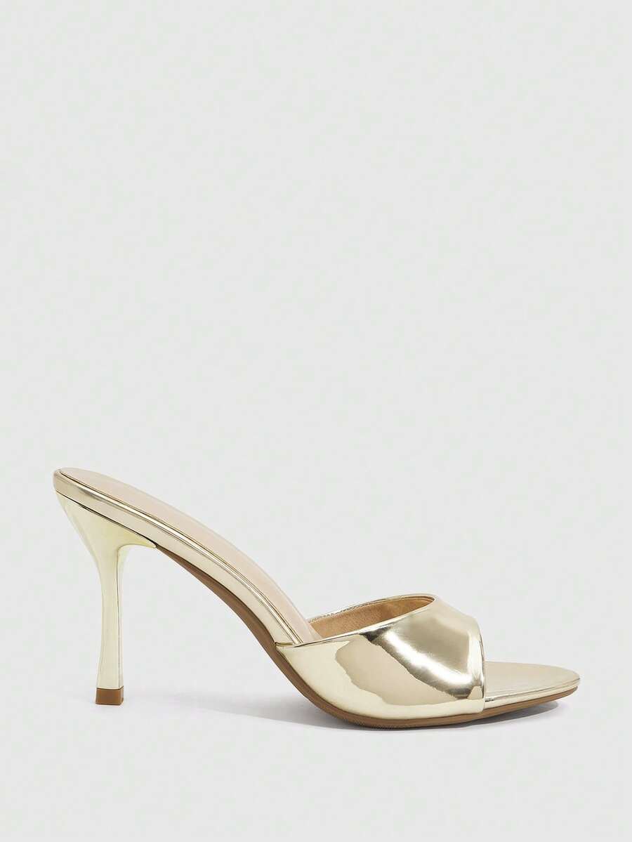 Women's peep toe high-heeled stiletto sandals with slingback strap in light metallic finish.