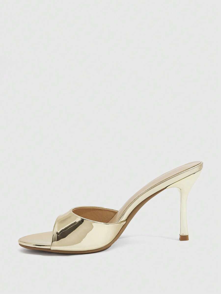 Women's peep toe high-heeled stiletto sandals with slingback strap in light metallic finish.