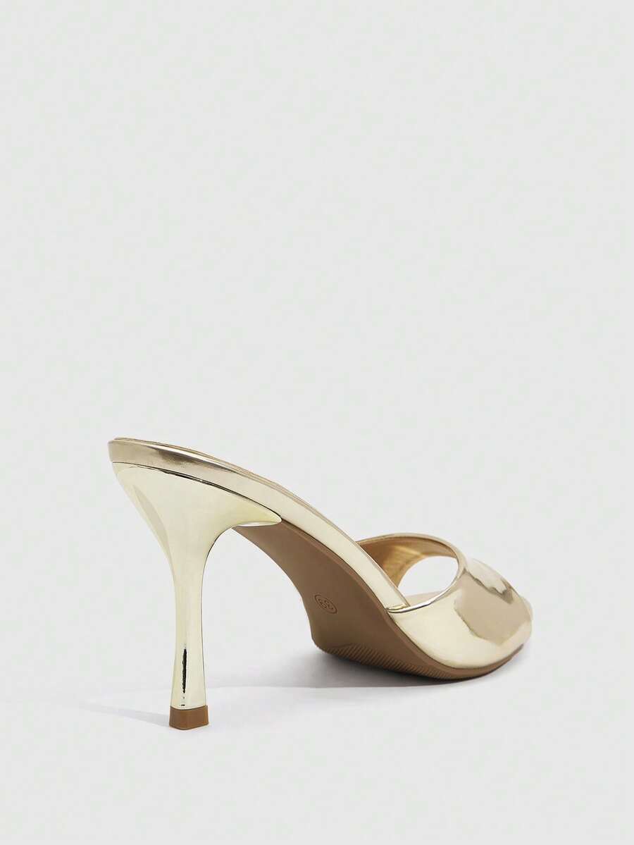Women's peep toe high-heeled stiletto sandals with slingback strap in light metallic finish.