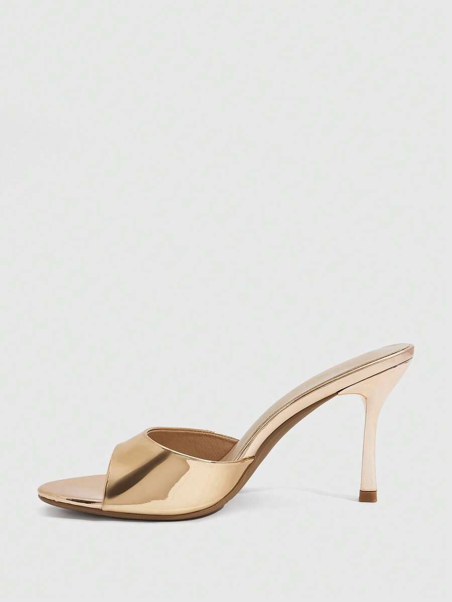 Women's peep toe high-heeled stiletto sandals with slingback strap in light metallic finish.