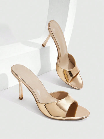 Women's peep toe high-heeled stiletto sandals with slingback strap in light metallic finish.