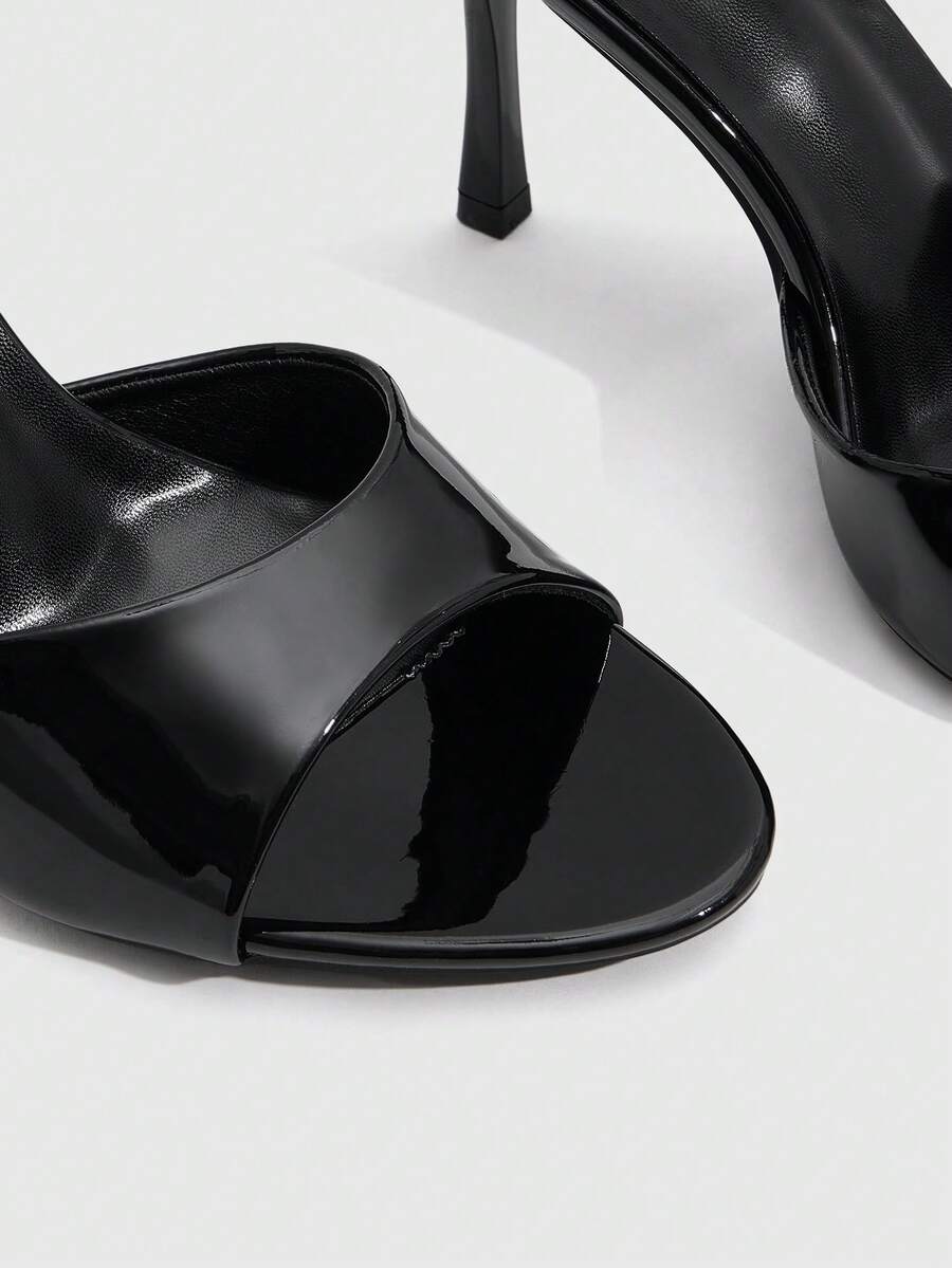 Women's peep toe high-heeled stiletto sandals with slingback strap in light metallic finish.