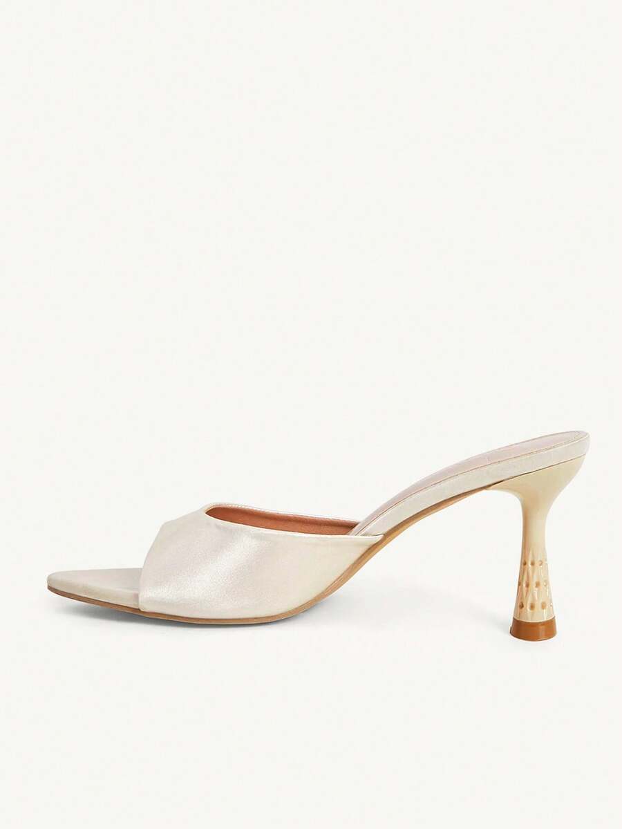 Elegant women's pointed toe heeled sandals with textured pattern and sleek stiletto heel
