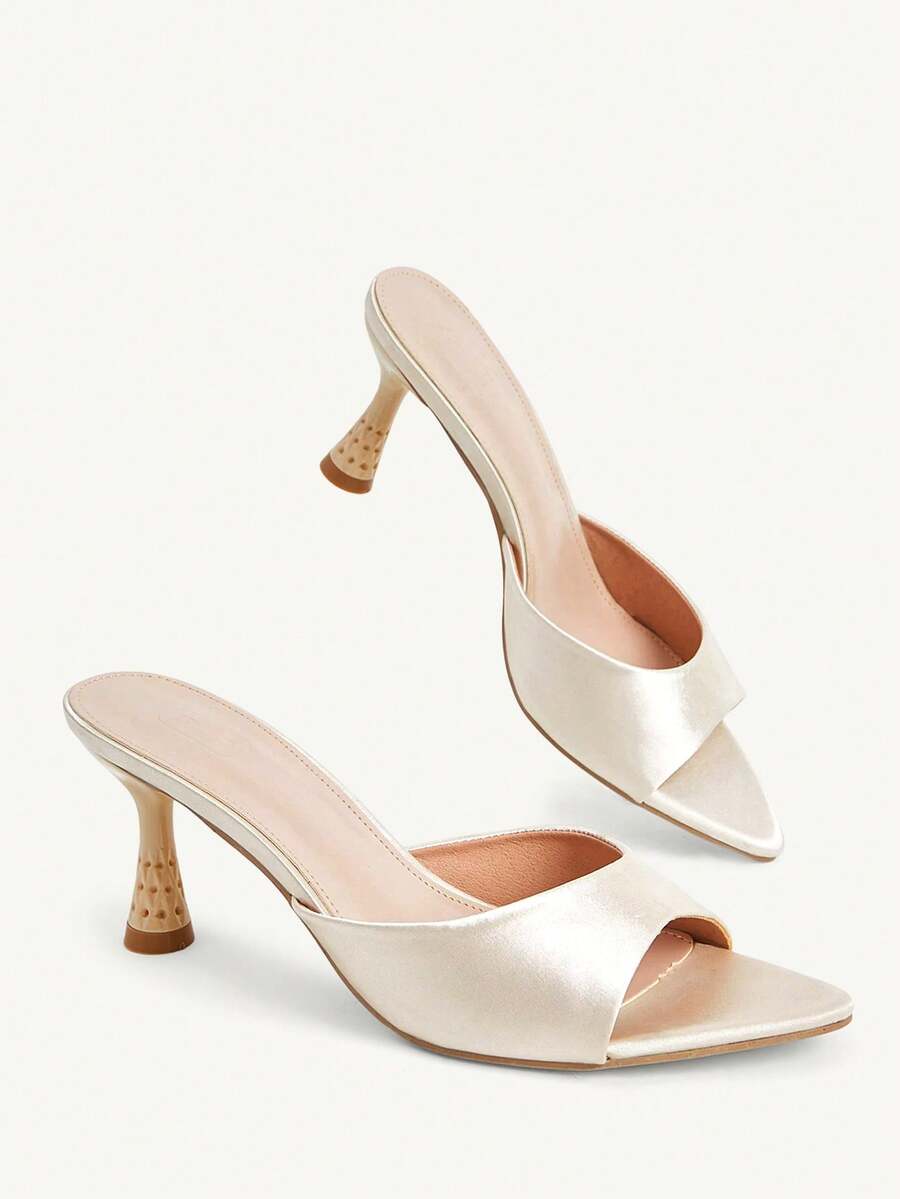 Elegant women's pointed toe heeled sandals with textured pattern and sleek stiletto heel