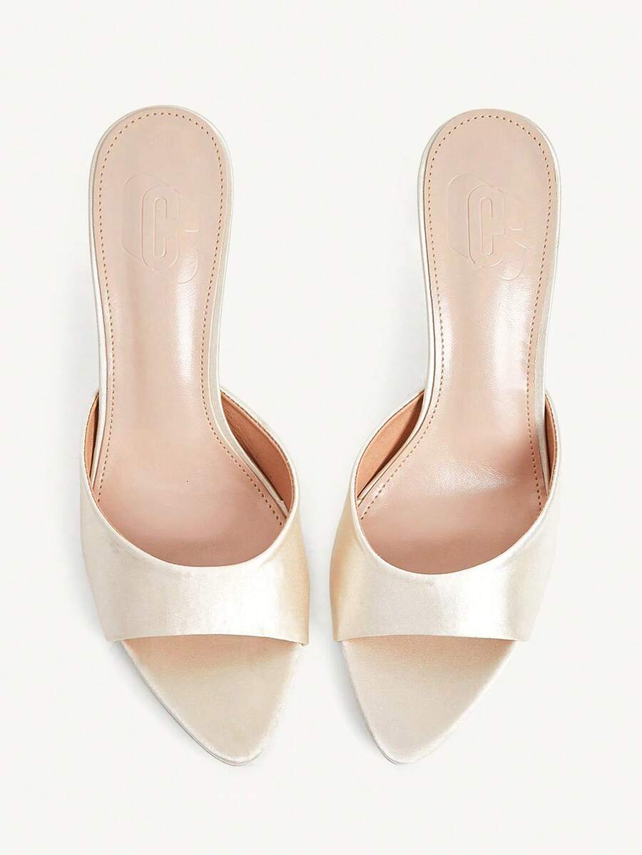 Elegant women's pointed toe heeled sandals with textured pattern and sleek stiletto heel