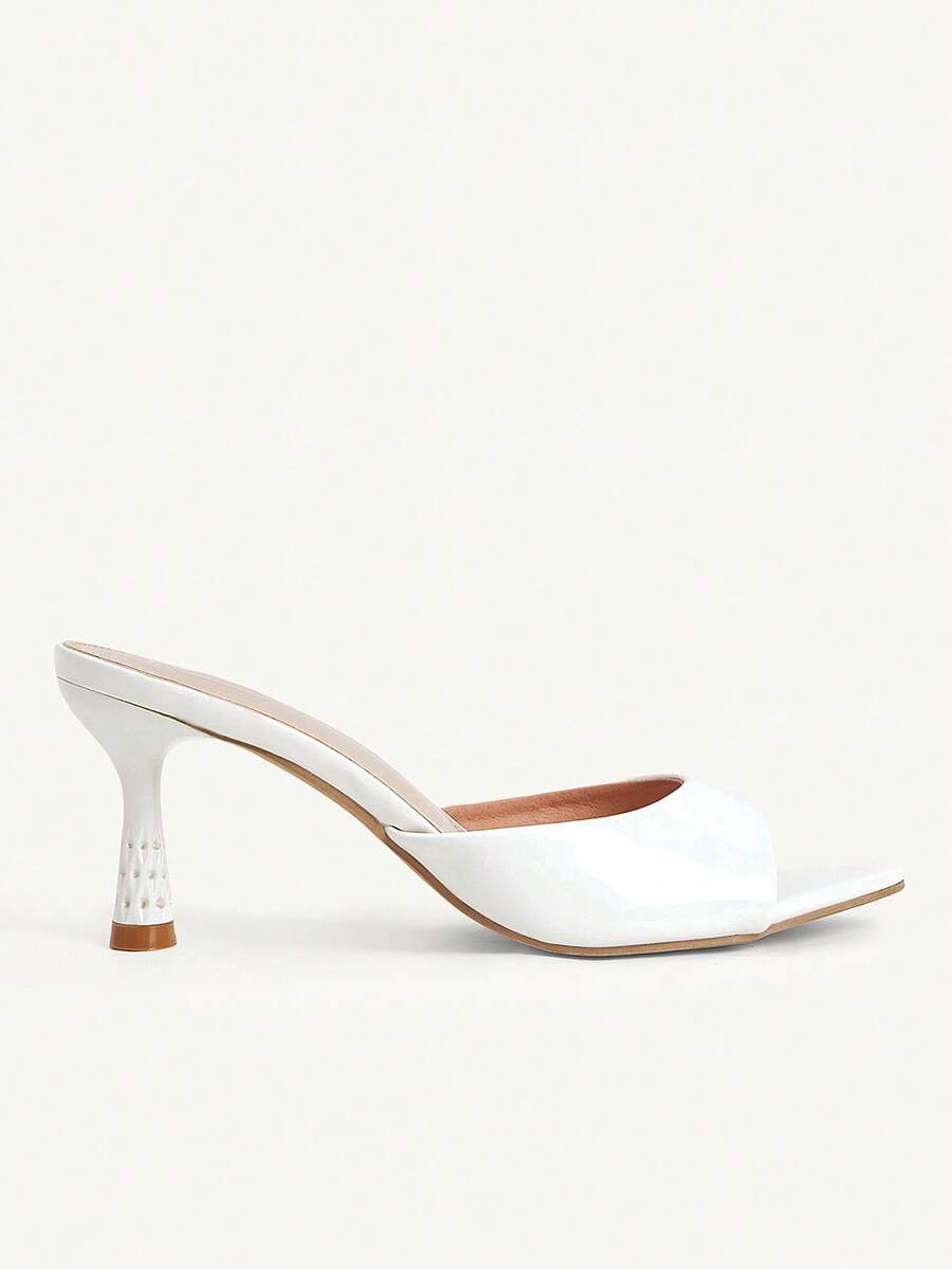 Elegant women's pointed toe heeled sandals with textured pattern and sleek stiletto heel