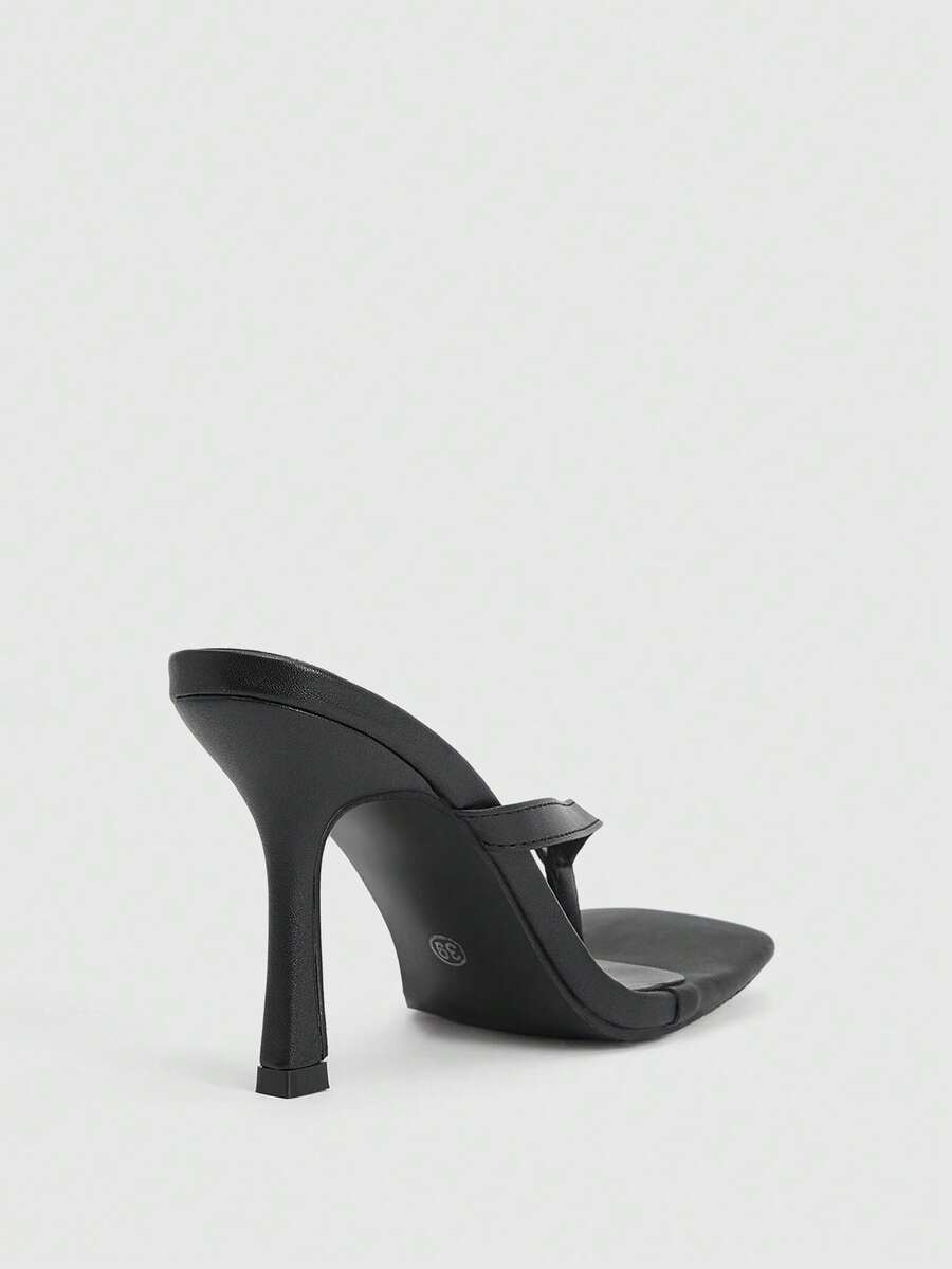 Women's black thong sandals featuring a criss-cross slingback strap and sleek kitten high heel, crafted in smooth PU leather with a rubber outsole.