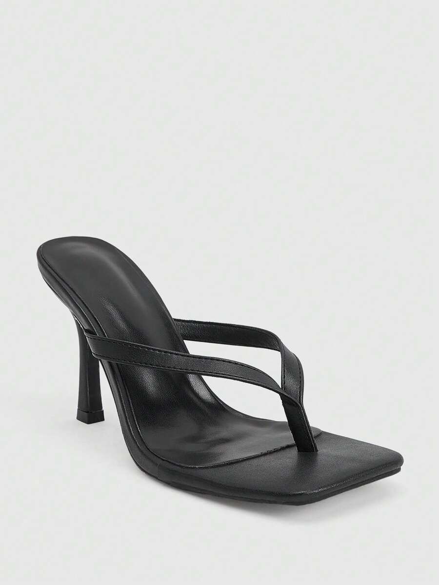 Women's black thong sandals featuring a criss-cross slingback strap and sleek kitten high heel, crafted in smooth PU leather with a rubber outsole.