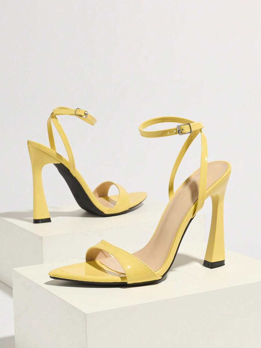 Burgundy open-toe high heels featuring an adjustable ankle strap with buckle closure and high stiletto heel.