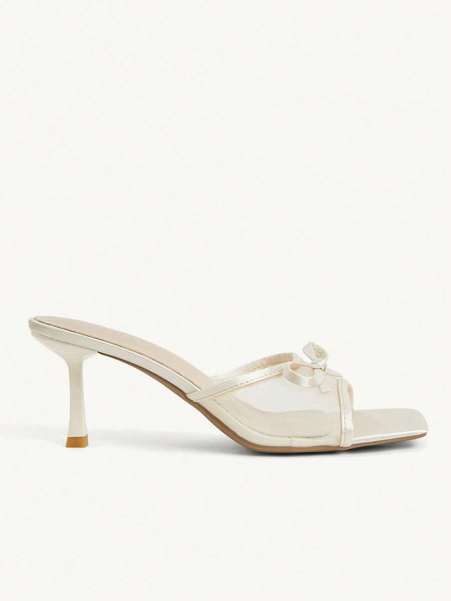 Pair of women's open toe stiletto heeled sandals crafted in satin with a bow accent