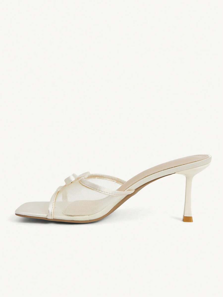 Pair of women's open toe stiletto heeled sandals crafted in satin with a bow accent