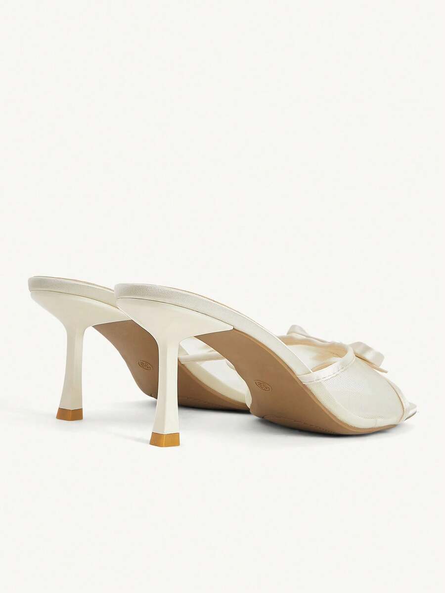 Pair of women's open toe stiletto heeled sandals crafted in satin with a bow accent