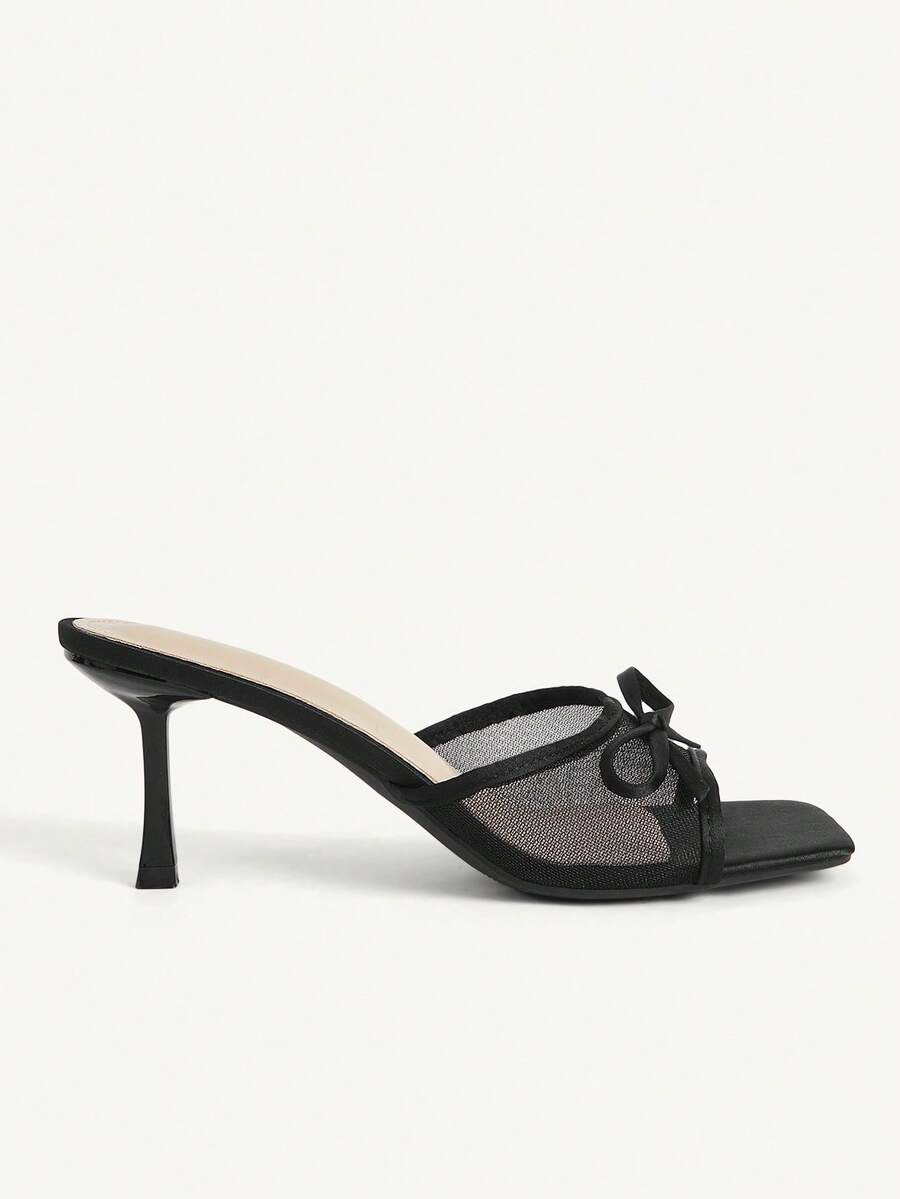 Pair of women's open toe stiletto heeled sandals crafted in satin with a bow accent