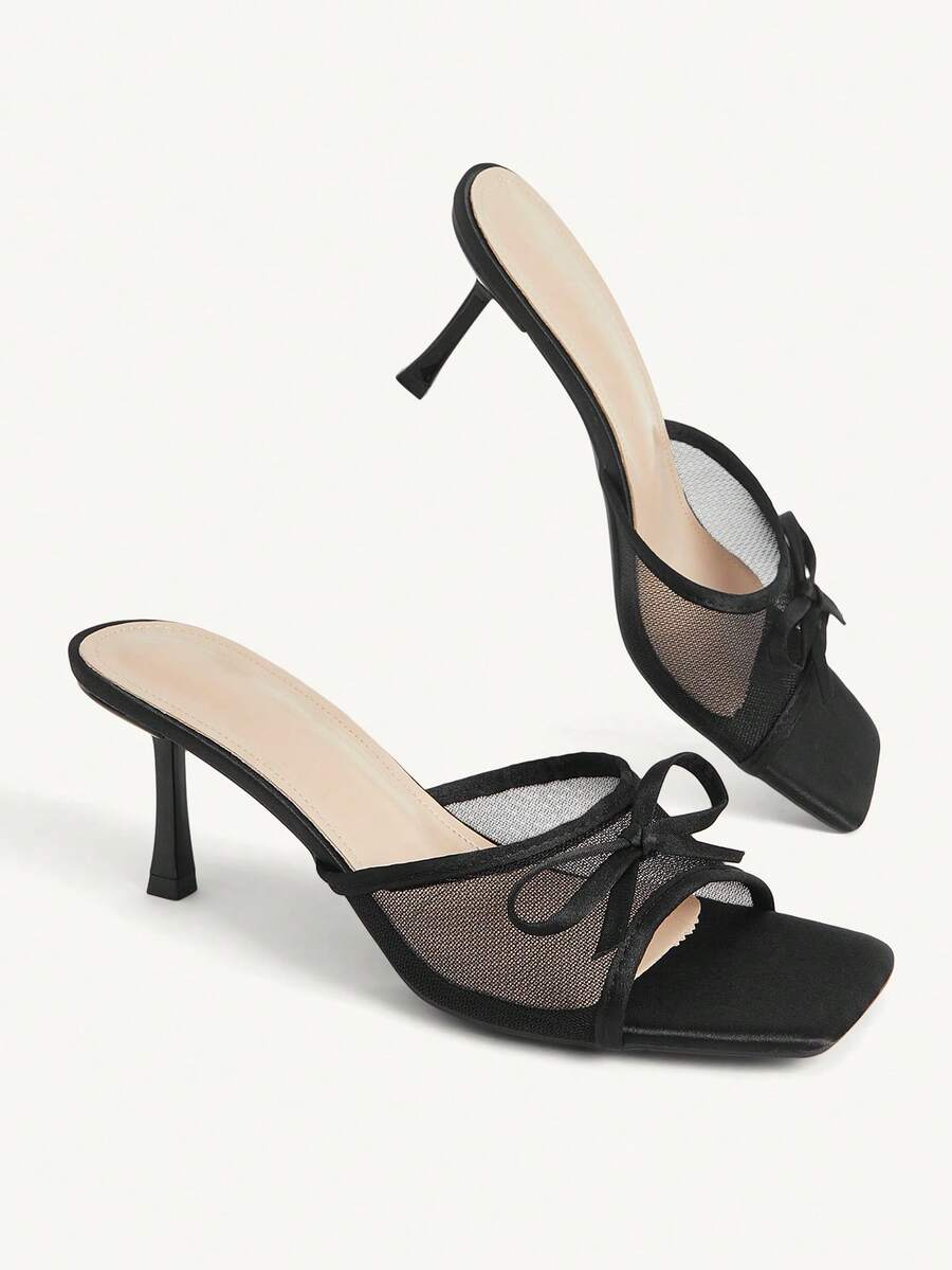 Pair of women's open toe stiletto heeled sandals crafted in satin with a bow accent