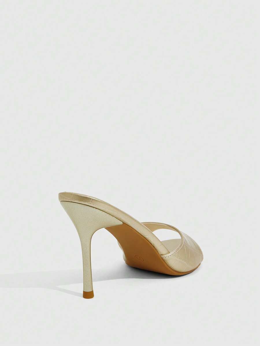 Elegant women's pointed toe heeled sandals with textured pattern and sleek stiletto heel
