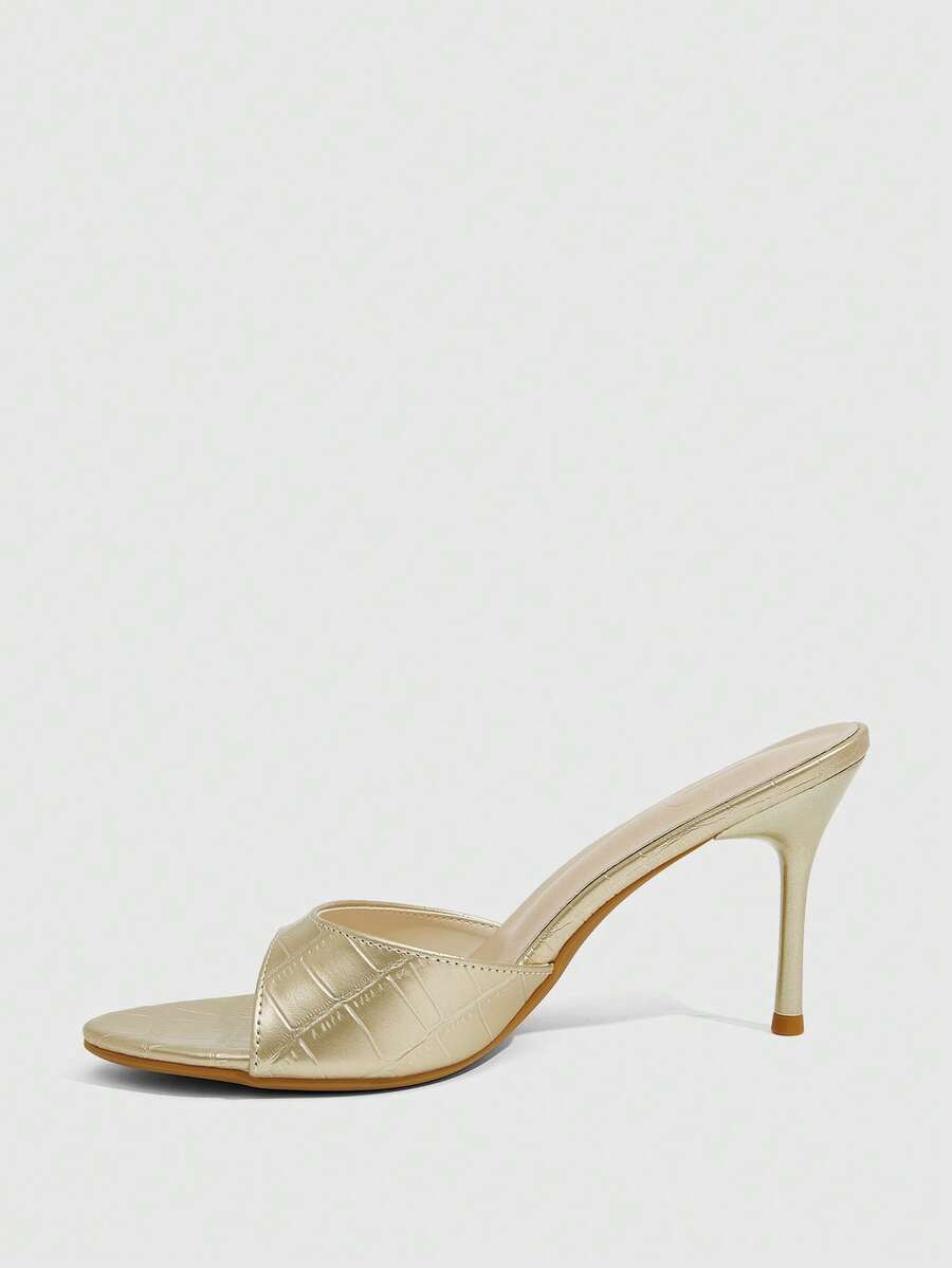 Elegant women's pointed toe heeled sandals with textured pattern and sleek stiletto heel