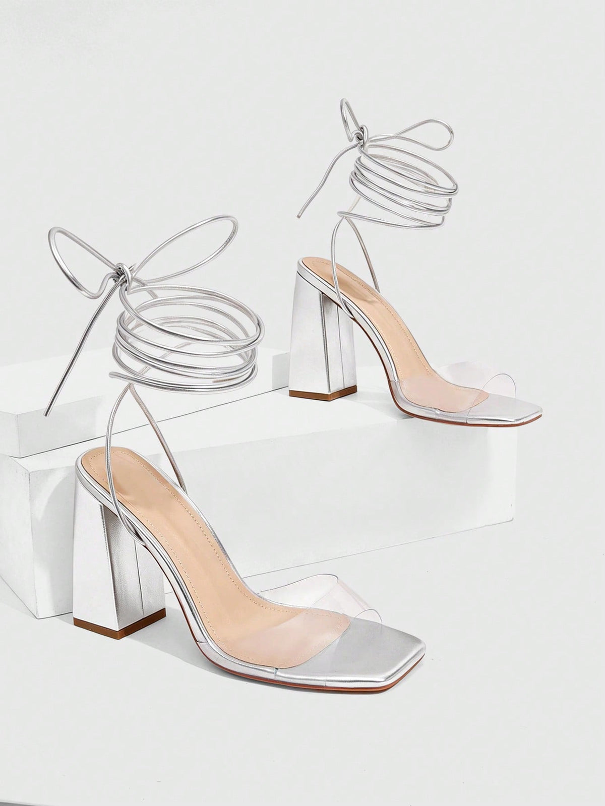 Women's criss-cross lace-up chunky high heel sandals with open square toe and strappy design.