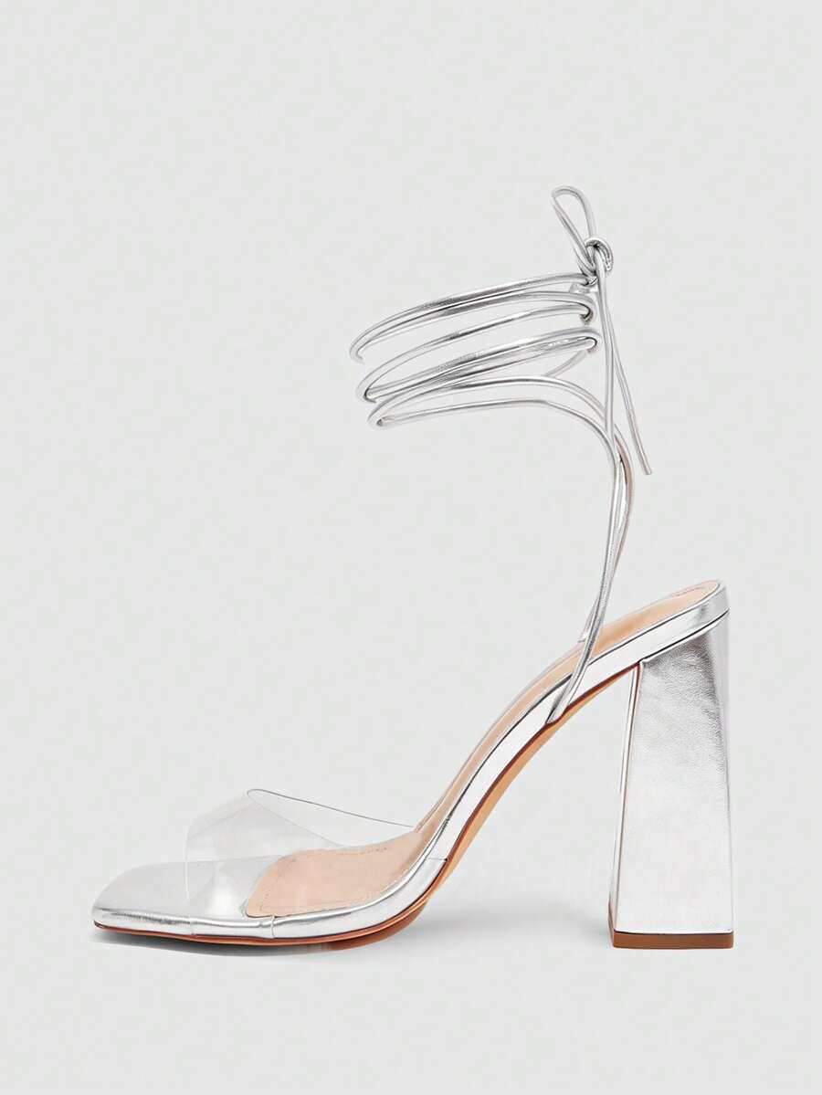 Women's criss-cross lace-up chunky high heel sandals with open square toe and strappy design.