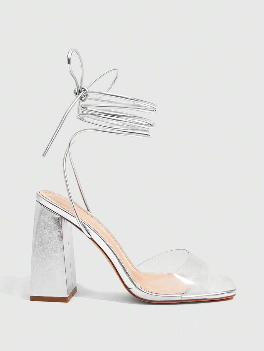Women's criss-cross lace-up chunky high heel sandals with open square toe and strappy design.