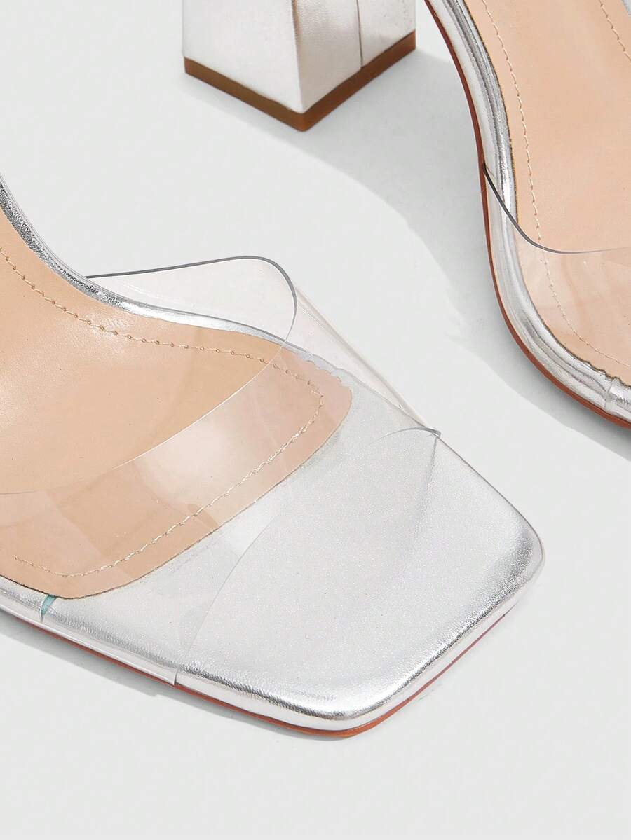 Women's criss-cross lace-up chunky high heel sandals with open square toe and strappy design.