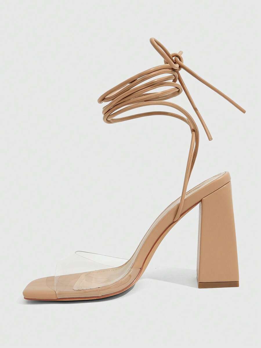 Women's criss-cross lace-up chunky high heel sandals with open square toe and strappy design.