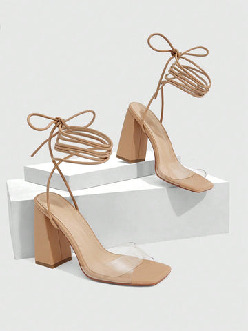 Women's criss-cross lace-up chunky high heel sandals with open square toe and strappy design.