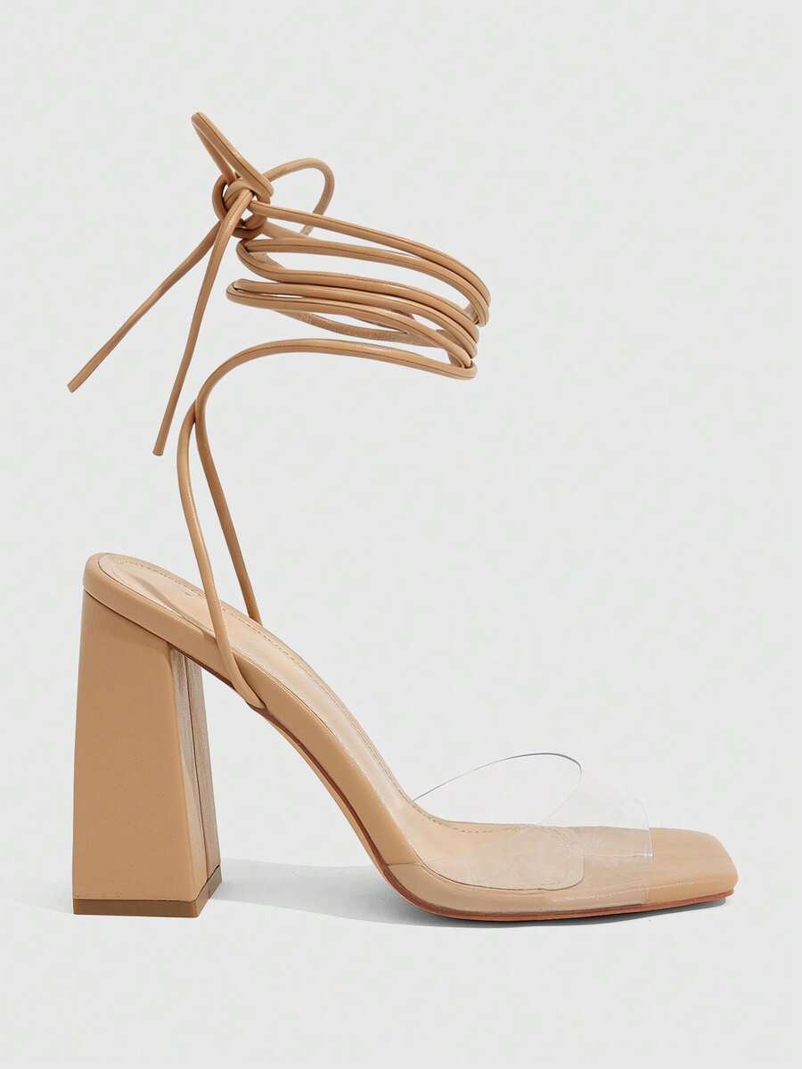 Women's criss-cross lace-up chunky high heel sandals with open square toe and strappy design.