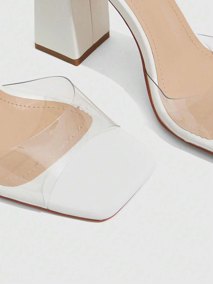 Women's criss-cross lace-up chunky high heel sandals with open square toe and strappy design.