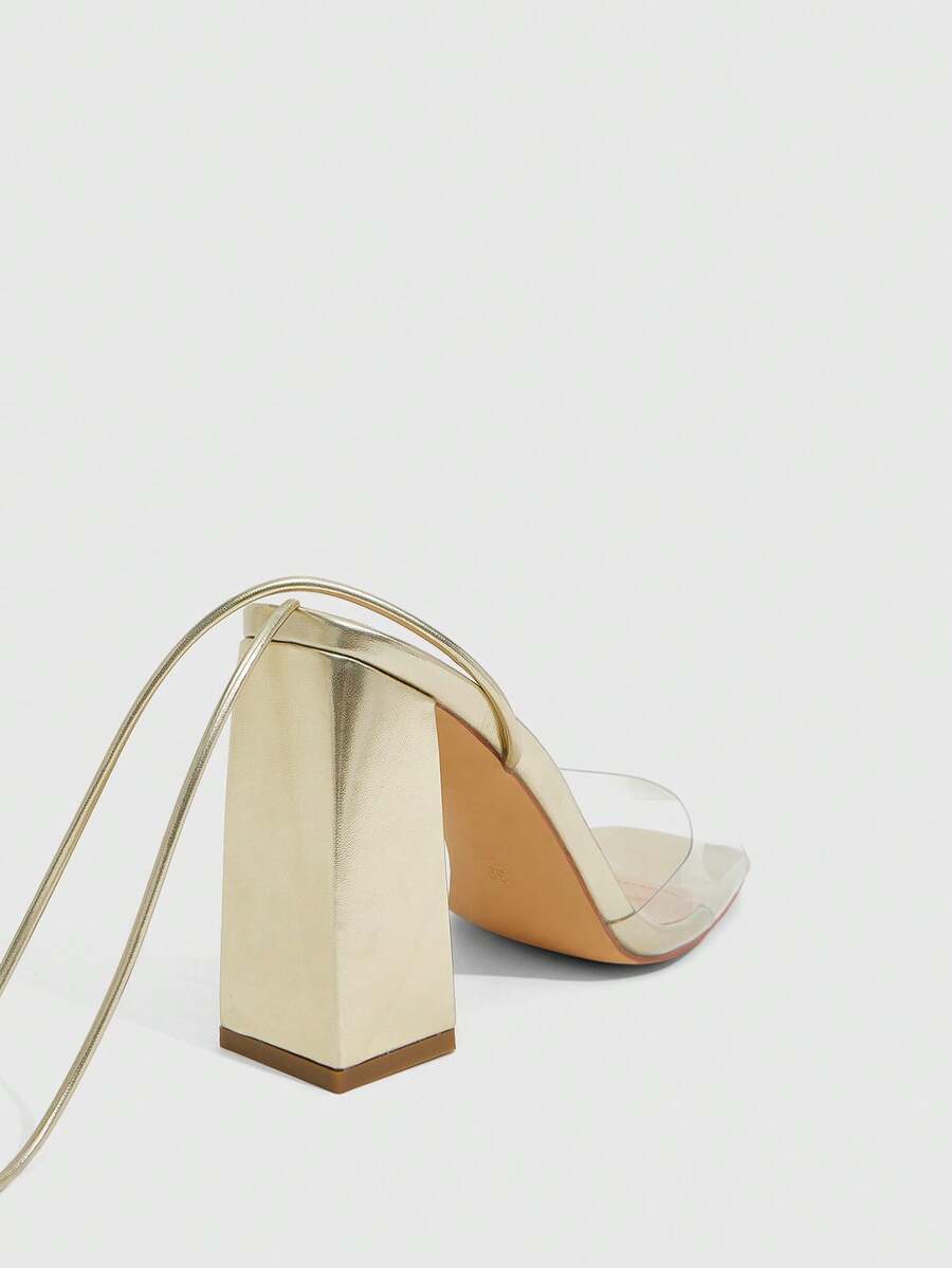 Women's criss-cross lace-up chunky high heel sandals with open square toe and strappy design.