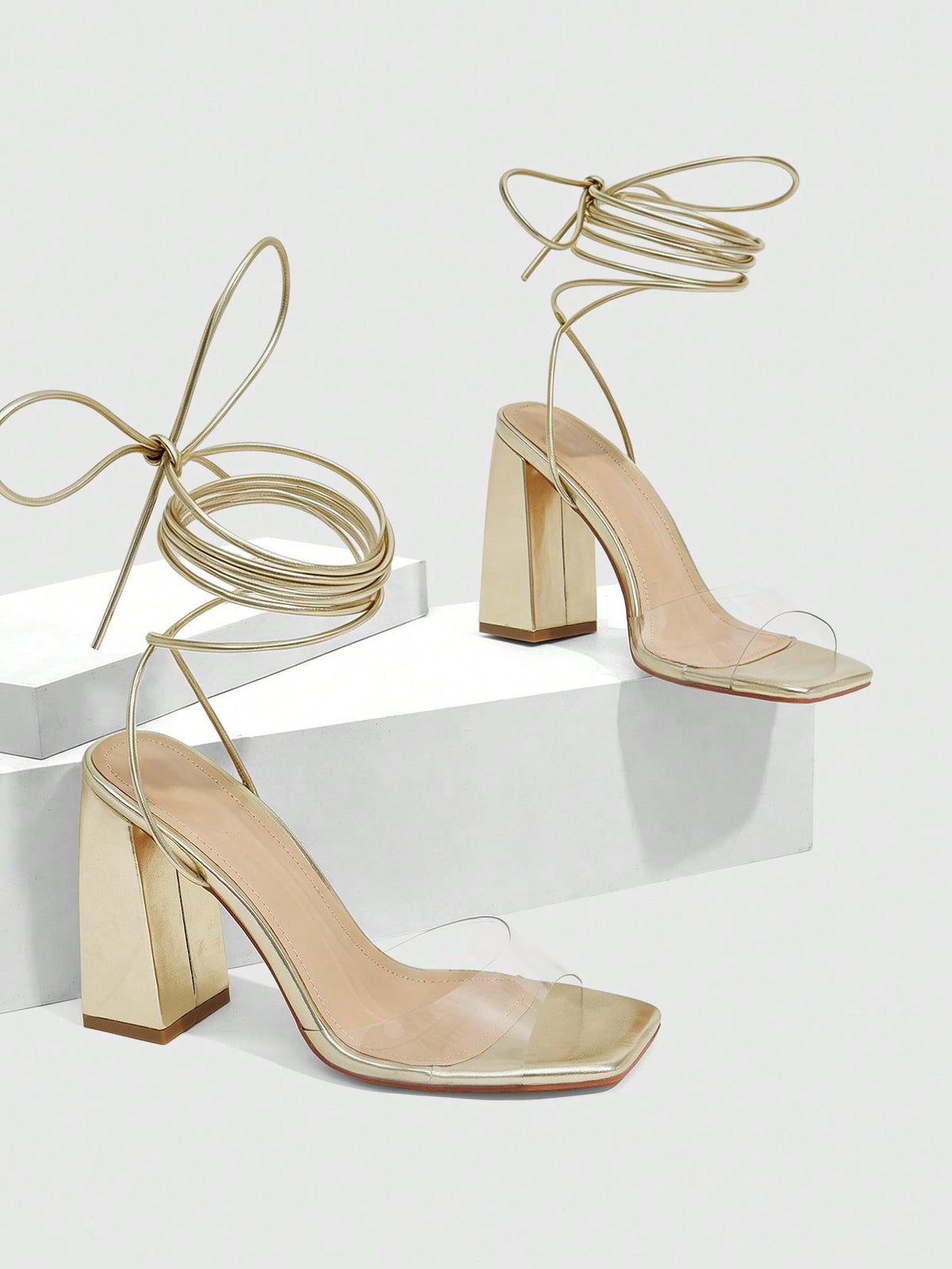 Women's criss-cross lace-up chunky high heel sandals with open square toe and strappy design.