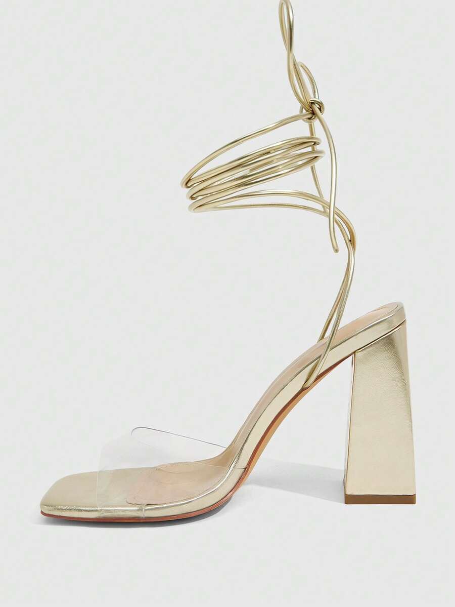 Women's criss-cross lace-up chunky high heel sandals with open square toe and strappy design.