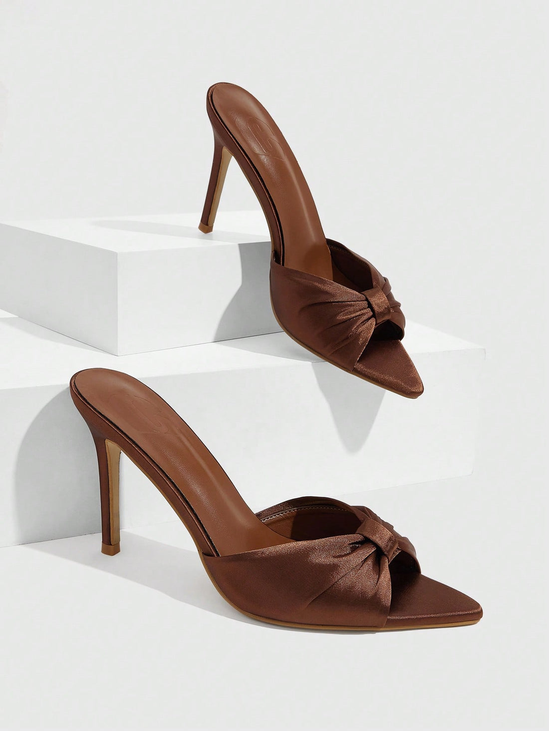 Women's bronze pleated satin stiletto sandals with an open toe design and adjustable buckle slingback strap.