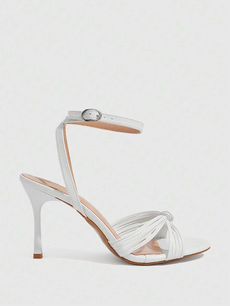 Women's high heel sandals featuring pleated strap detailing, an adjustable ankle strap with buckle closure, round open toe, and slim stiletto heel.