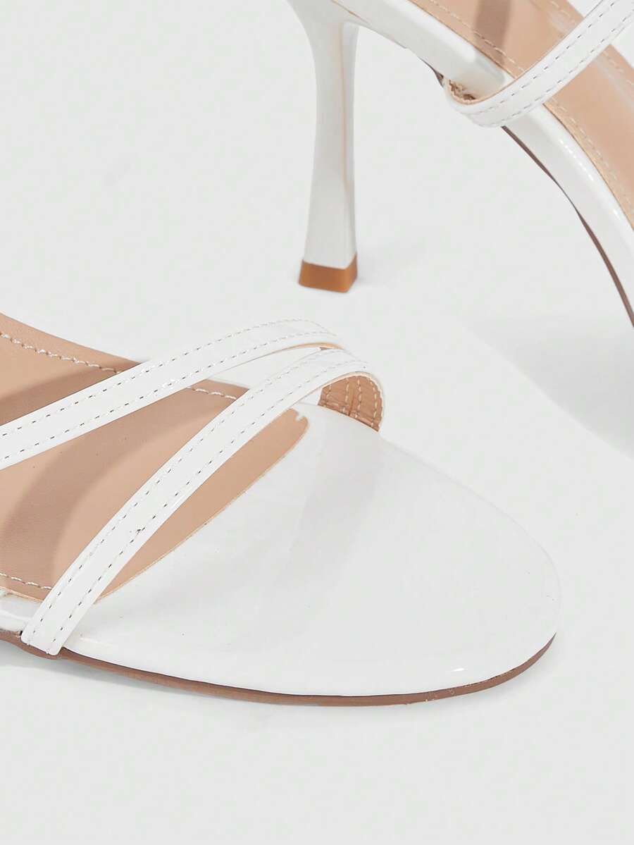 Women's square toe stiletto high heeled sandals with ankle strap buckle in a sleek faux leather finish.