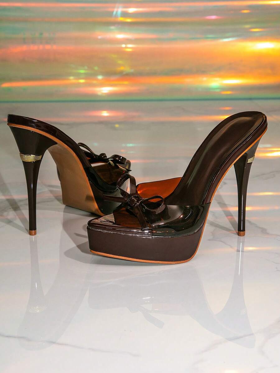 Women's brown platform high heel sandals with pointed toe, decorative bow, and lace-up stiletto design.