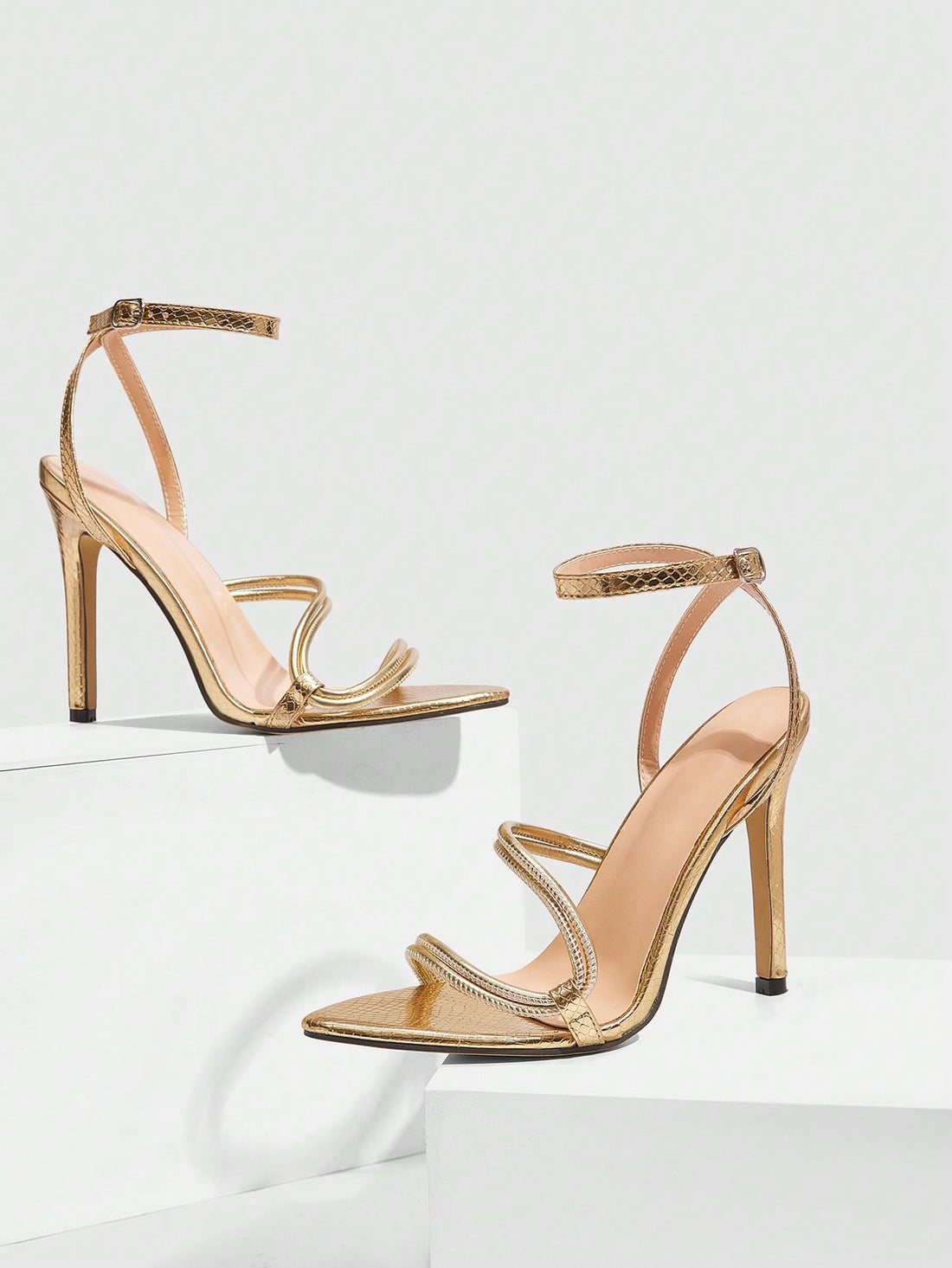 Snake pattern open toe high heel sandals with thin stiletto heel and buckle ankle strap for women.