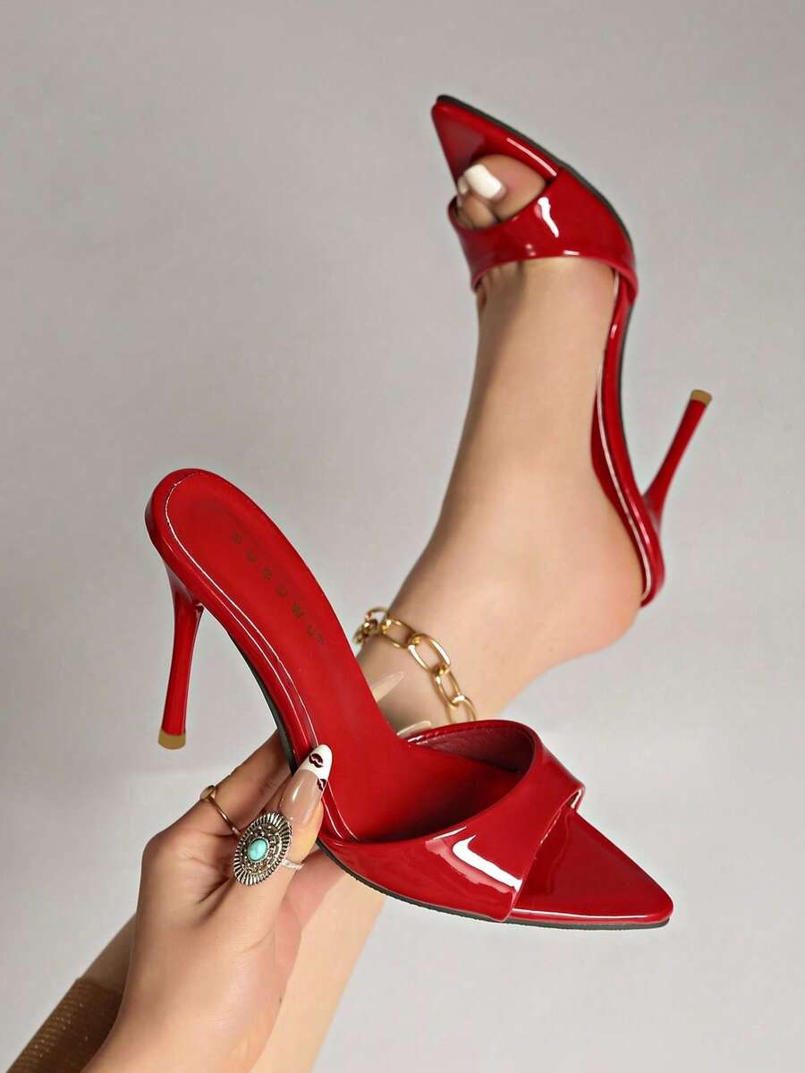 Patent leather open toe slingback slide sandals with stiletto high heels and slip on design.