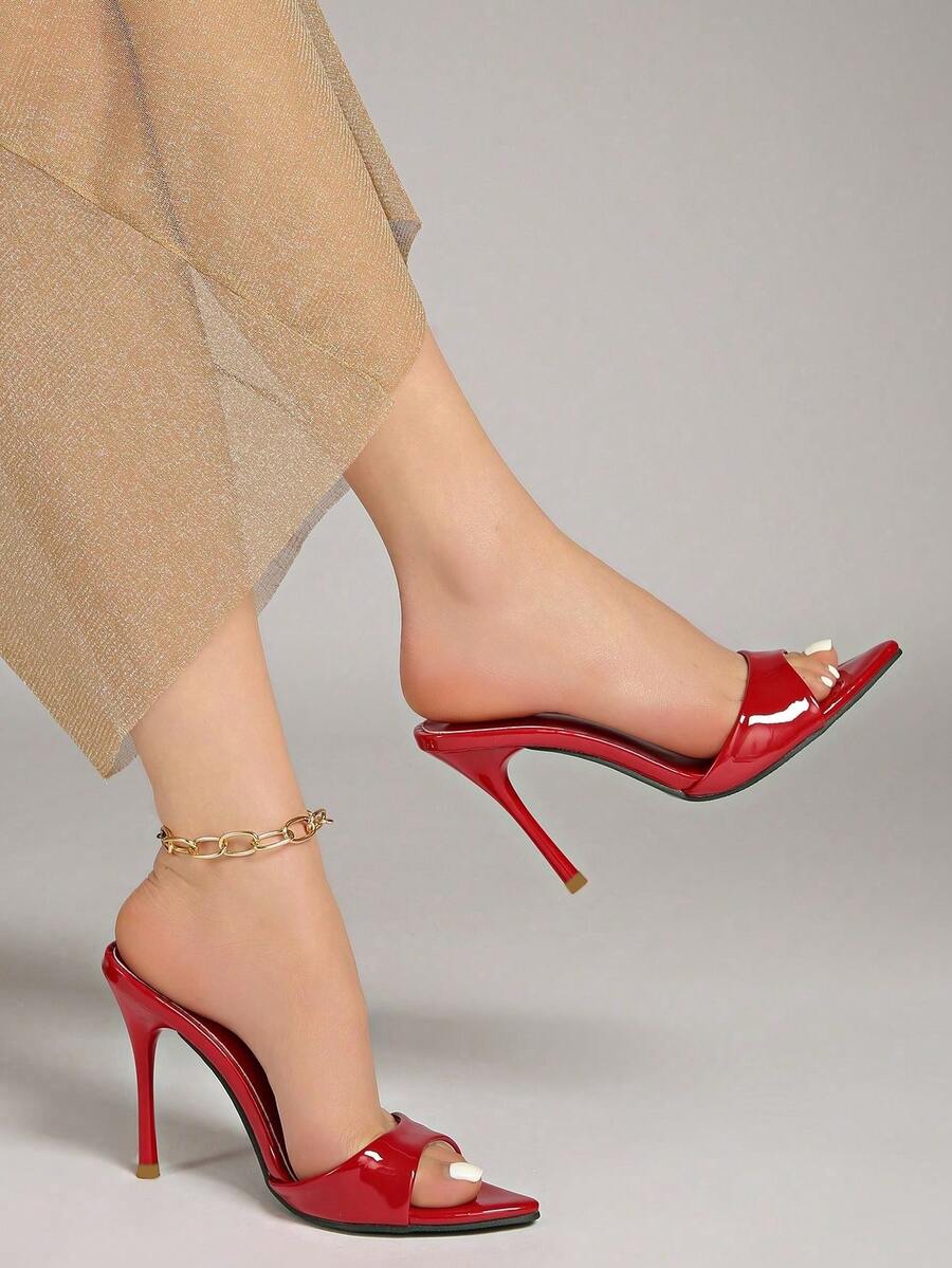 Patent leather open toe slingback slide sandals with stiletto high heels and slip on design.
