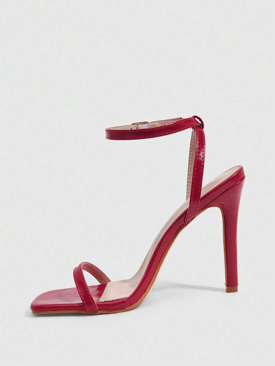 Elegant women's open toe strappy heeled sandals with stiletto high heel and ankle strap buckle closure.