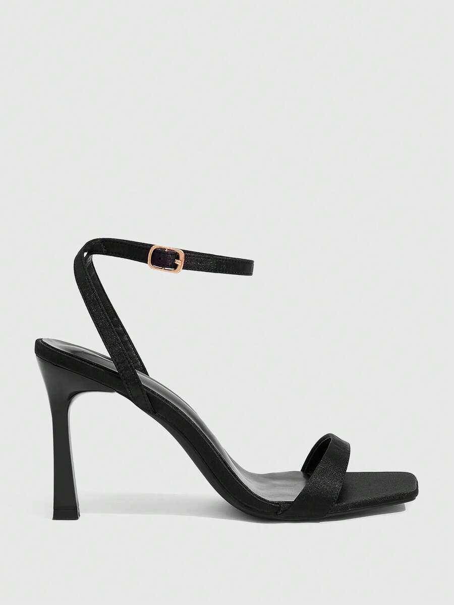 Women's high heel ankle strap sandals with open toe and stiletto heel in mirror black finish.