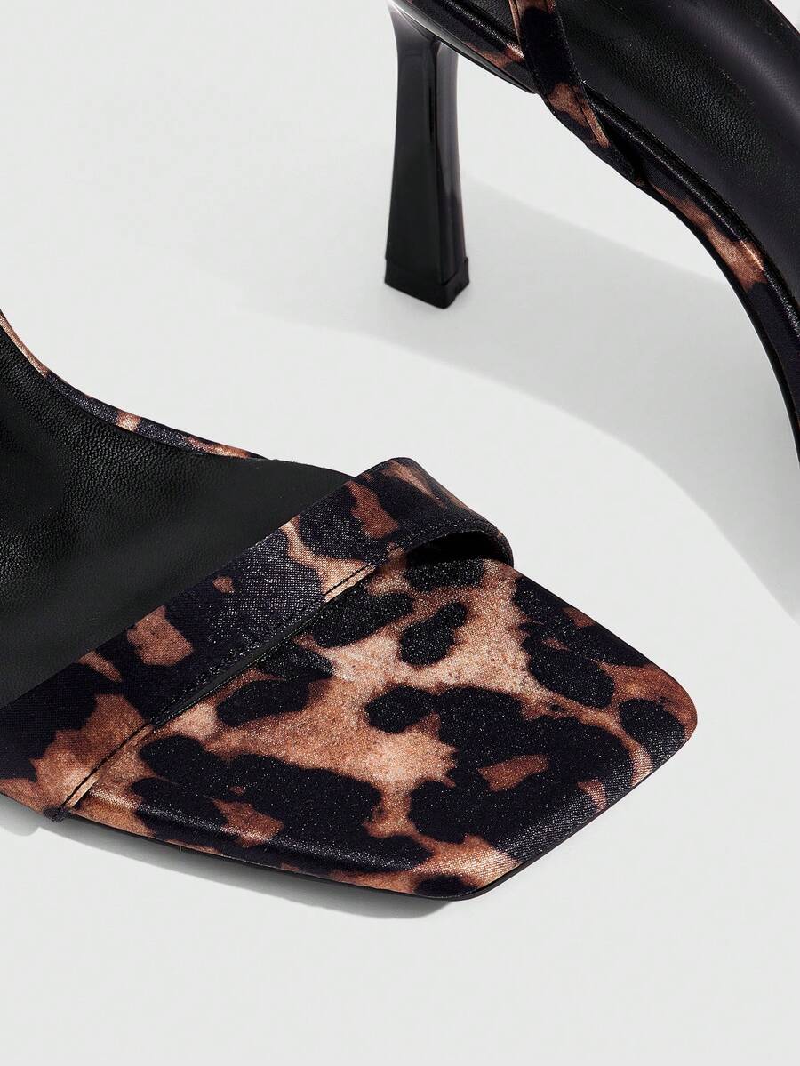 Women's high heel ankle strap sandals with open toe and stiletto heel in mirror black finish.