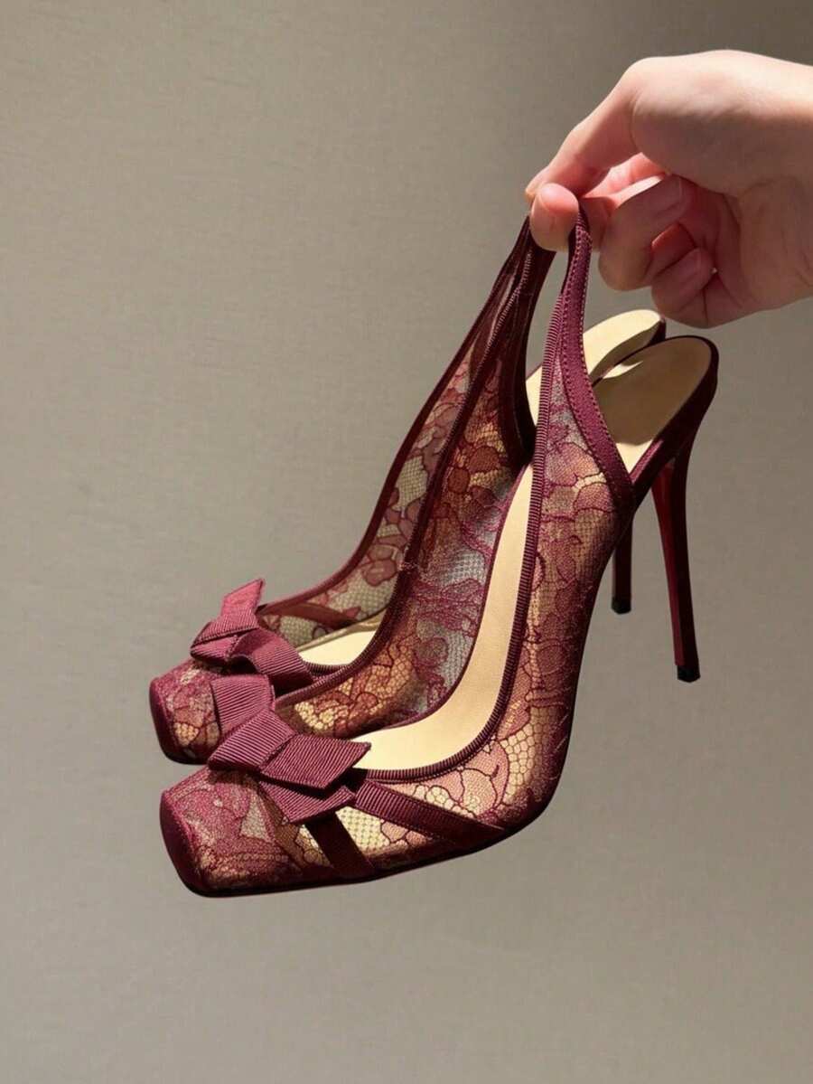 Black lace high heel sandals for women with a big bowknot, closed square toe, and stiletto heel.