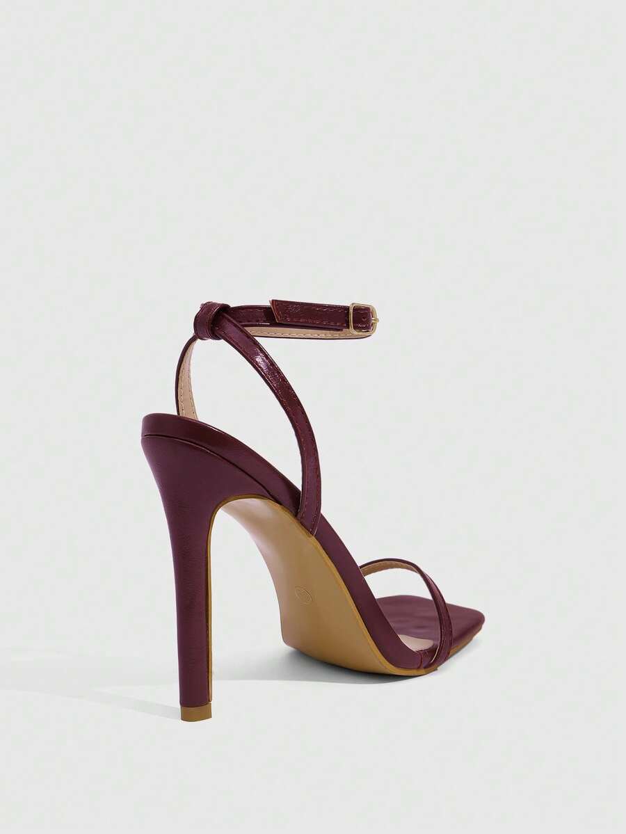 Elegant women's open toe strappy heeled sandals with stiletto high heel and ankle strap buckle closure.