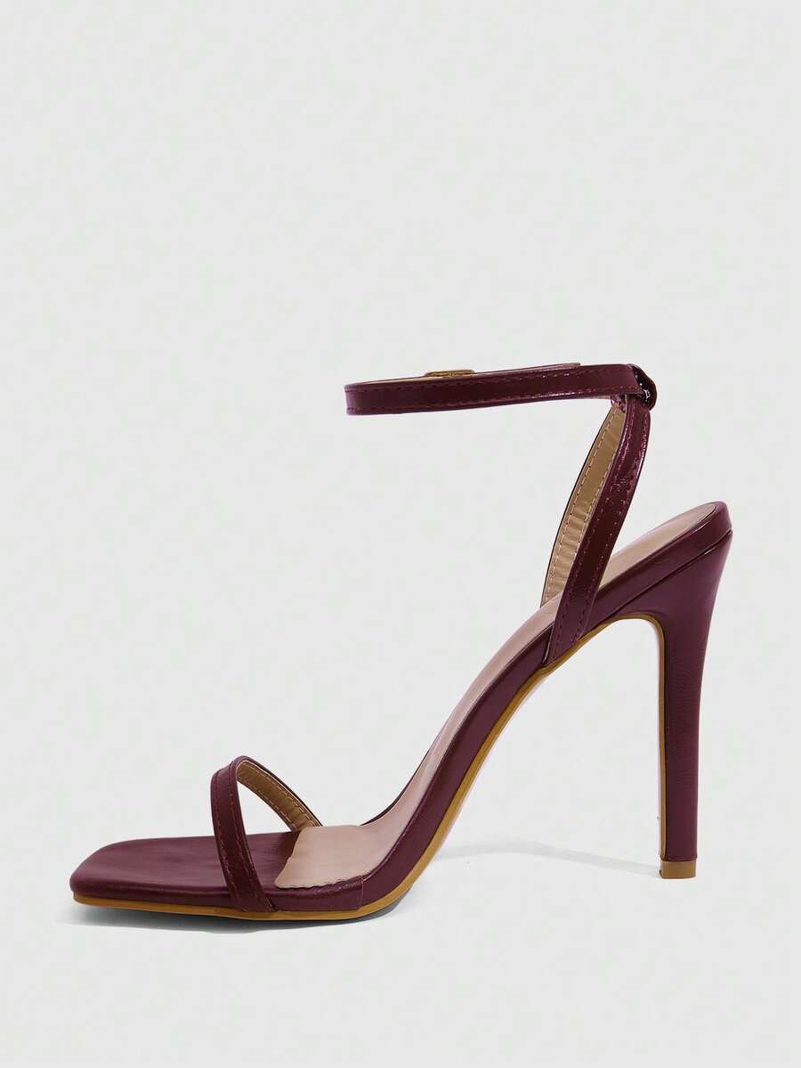 Elegant women's open toe strappy heeled sandals with stiletto high heel and ankle strap buckle closure.