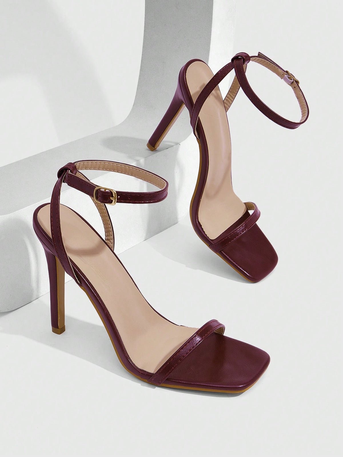 Elegant women's open toe strappy heeled sandals with stiletto high heel and ankle strap buckle closure.