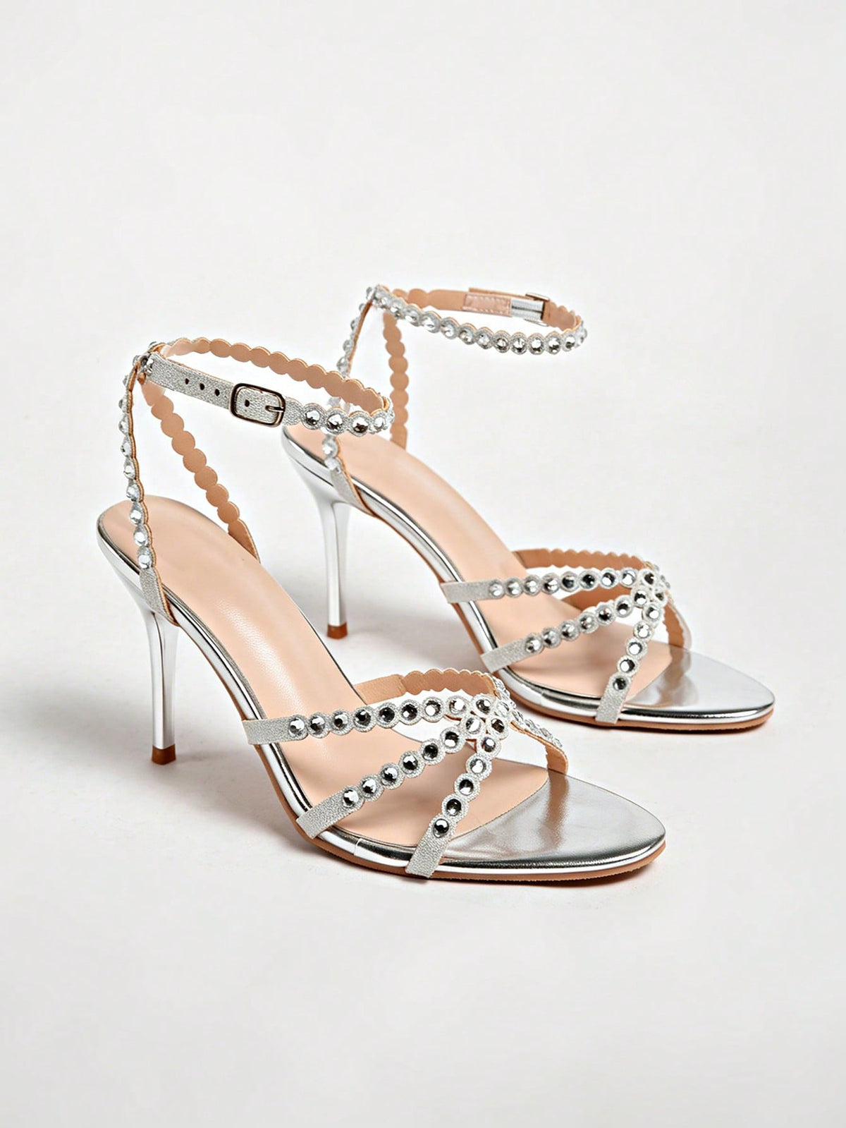 Women's open toe stiletto high heel sandals featuring metallic knot decor and an adjustable ankle buckle strap.